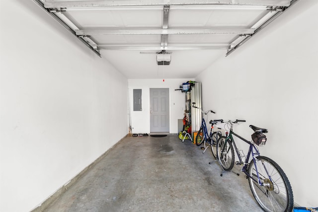 garage with a garage door opener and electric panel