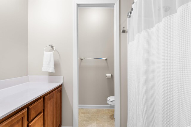 bathroom featuring tile patterned floors, vanity, and toilet