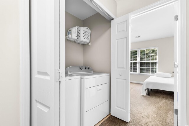 clothes washing area with carpet floors and independent washer and dryer