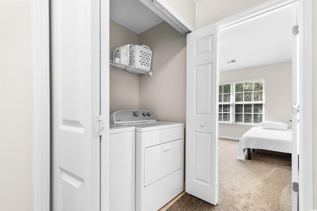 washroom featuring laundry area, carpet flooring, independent washer and dryer, and visible vents