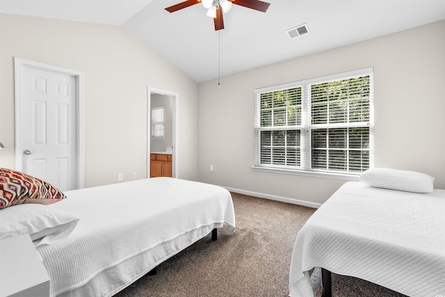 bedroom featuring ceiling fan, vaulted ceiling, ensuite bath, and carpet