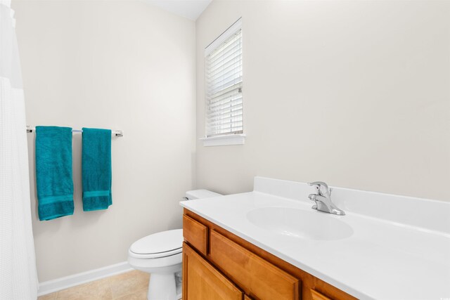 bathroom featuring tile patterned floors, vanity, and toilet