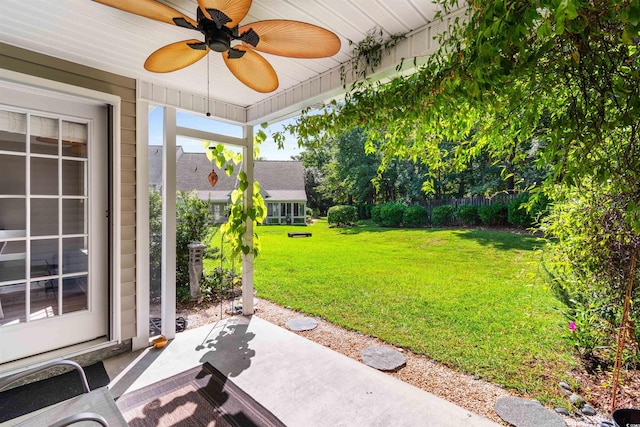 view of yard featuring a ceiling fan and a patio