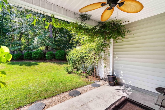 view of yard with a patio area, ceiling fan, and fence