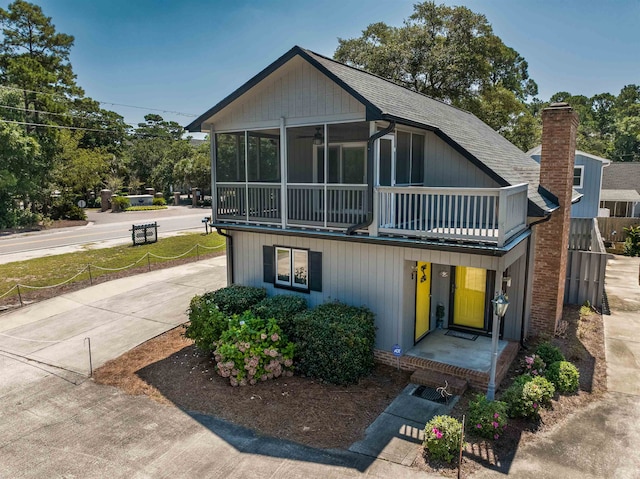 view of front of home with a balcony and a sunroom