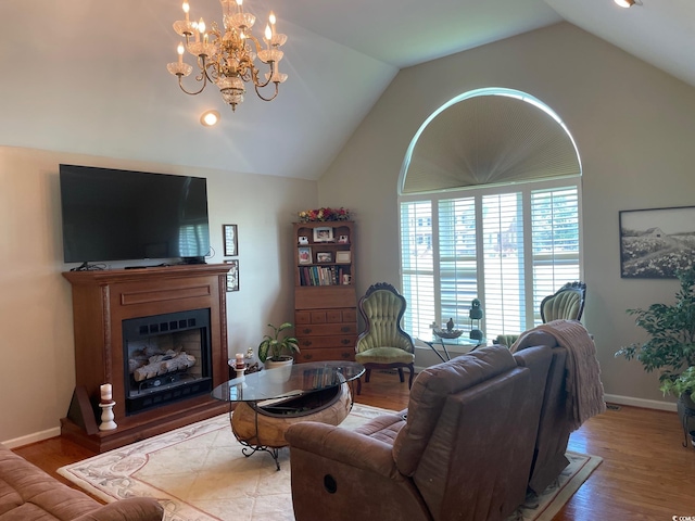 living room featuring an inviting chandelier, lofted ceiling, and hardwood / wood-style flooring