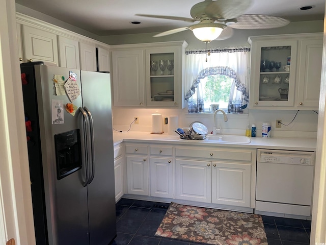 kitchen with ceiling fan, white cabinets, stainless steel fridge, dark tile patterned floors, and dishwasher