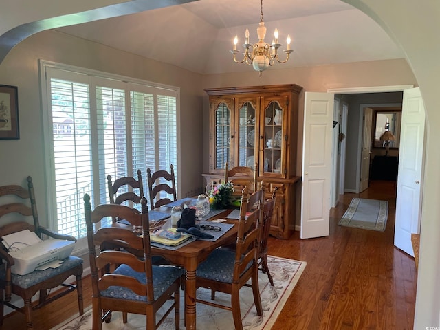 dining area featuring a notable chandelier and dark wood-type flooring