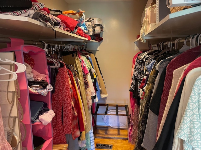 spacious closet featuring hardwood / wood-style flooring