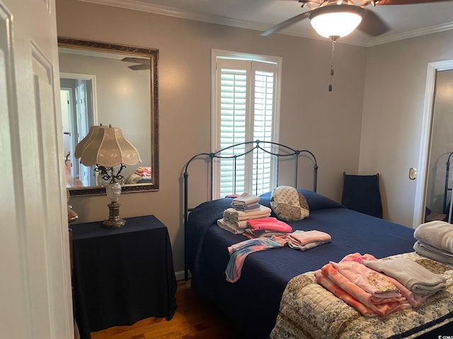 bedroom with wood-type flooring, ornamental molding, and ceiling fan