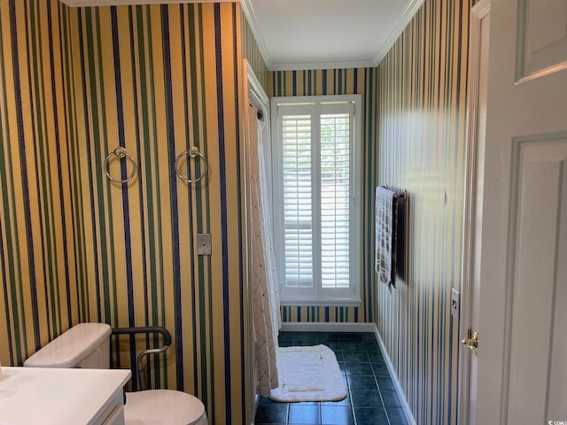 bathroom featuring vanity, crown molding, toilet, and tile patterned floors