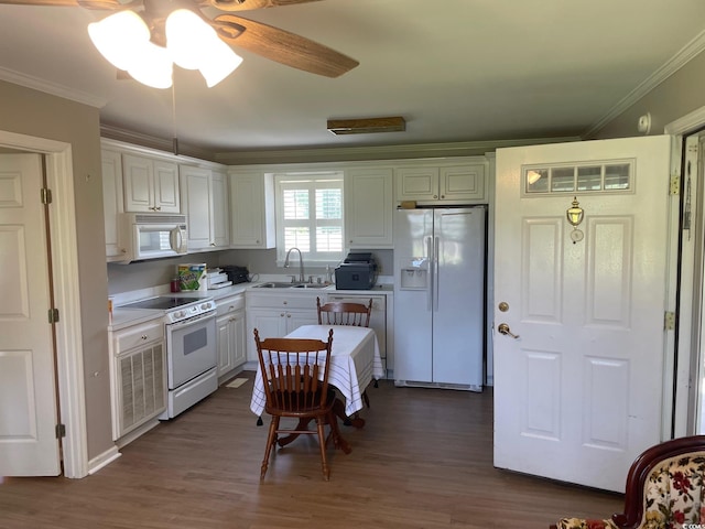 kitchen featuring white cabinetry, dark wood-type flooring, white appliances, ceiling fan, and sink