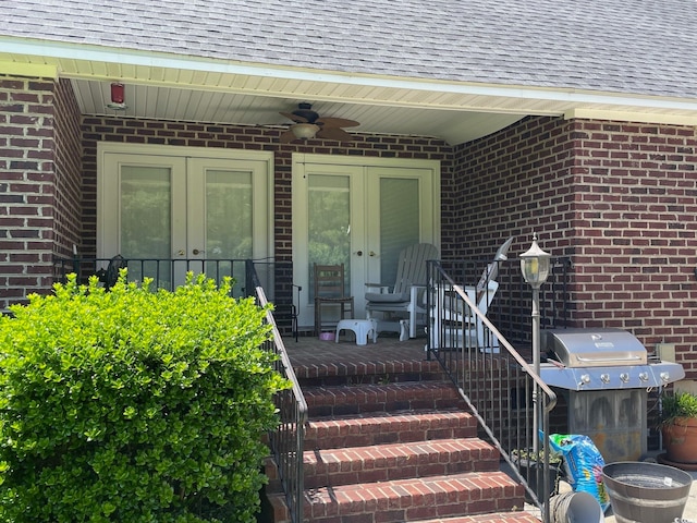 view of exterior entry featuring ceiling fan and french doors