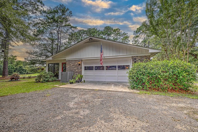 view of front of property with central air condition unit and a garage