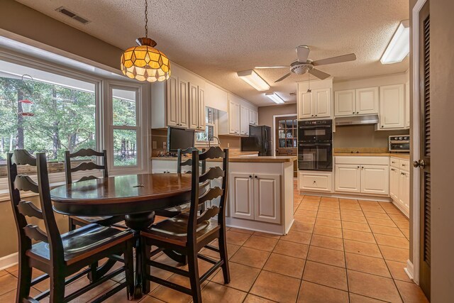 kitchen with ceiling fan, white cabinetry, light tile patterned floors, and black appliances