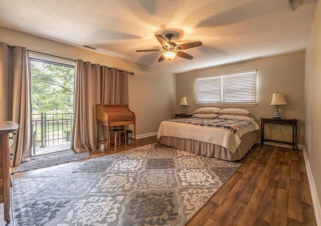 bedroom featuring a textured ceiling, ceiling fan, access to exterior, and dark hardwood / wood-style floors