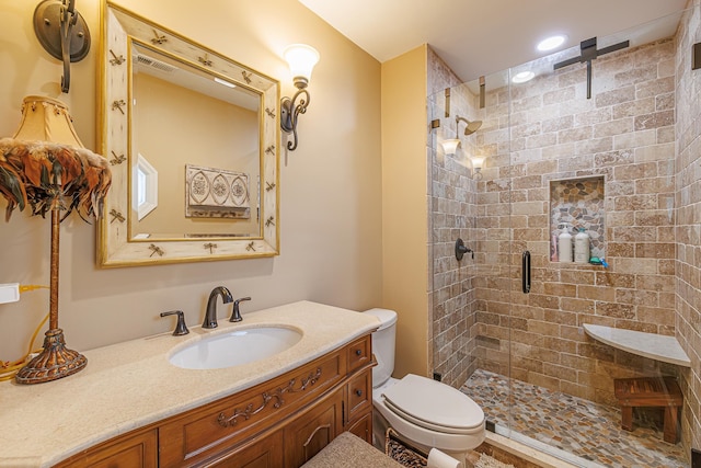 bathroom with toilet, an enclosed shower, and vanity