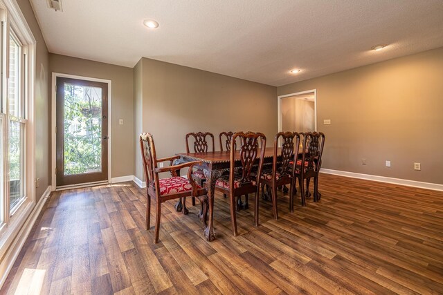 dining room featuring a textured ceiling and hardwood / wood-style floors