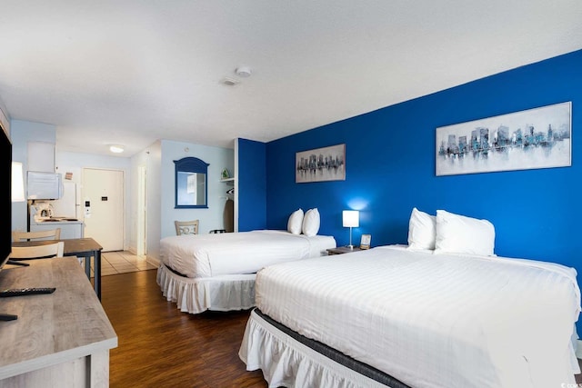 bedroom with dark wood-type flooring