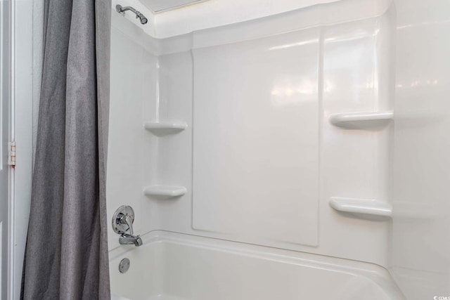 bathroom with shower / bath combo with shower curtain