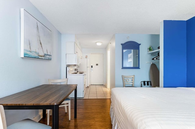 tiled bedroom with a textured ceiling