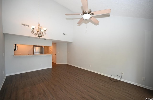 unfurnished living room featuring ceiling fan with notable chandelier, dark hardwood / wood-style flooring, and high vaulted ceiling