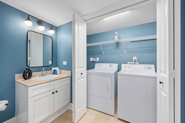 laundry area featuring sink, light tile patterned flooring, and separate washer and dryer