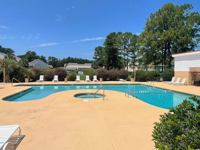 view of pool with a community hot tub and a patio area