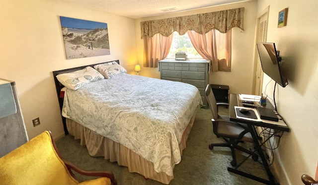 bedroom with carpet, visible vents, and a textured ceiling