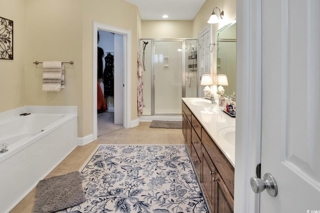 bathroom featuring tile patterned flooring, independent shower and bath, and dual bowl vanity