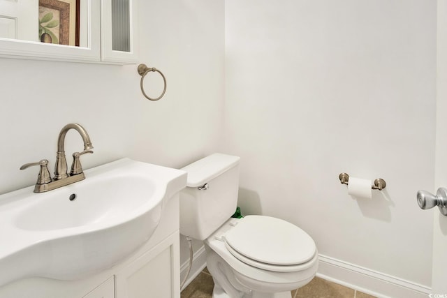 bathroom with tile patterned floors, vanity, and toilet