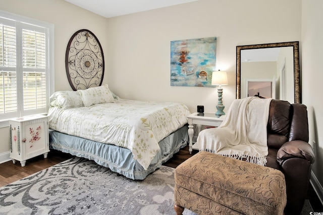 bedroom with dark wood-type flooring