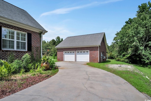 view of property exterior with a yard and a garage