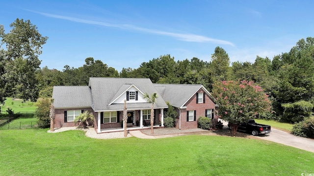 cape cod house with a front lawn