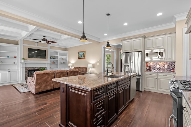 kitchen with coffered ceiling, stainless steel appliances, beamed ceiling, sink, and decorative light fixtures