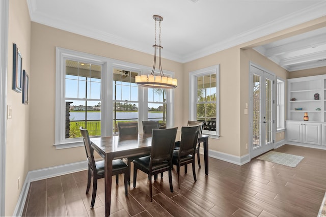 dining area with built in shelves, french doors, a water view, and plenty of natural light