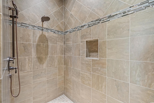 bathroom with a tile shower