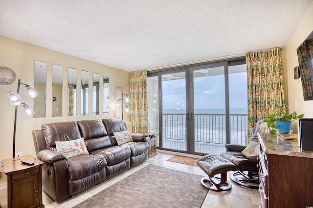 tiled living room featuring a textured ceiling