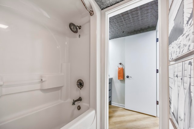 bathroom featuring shower / tub combination and wood-type flooring