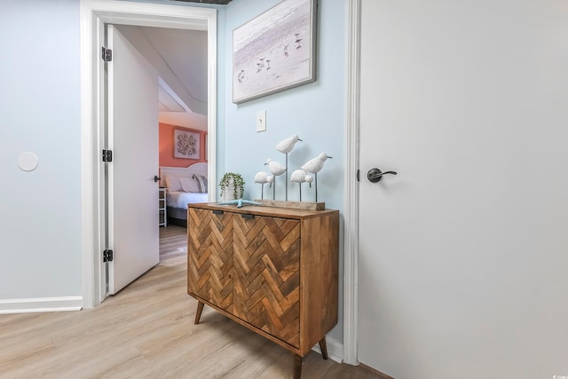 hallway with light hardwood / wood-style floors