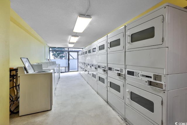 laundry room with a textured ceiling, stacked washing maching and dryer, and independent washer and dryer