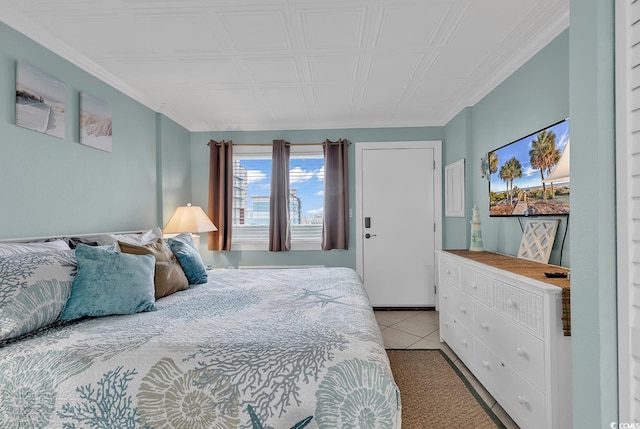 bedroom with crown molding and light tile patterned flooring