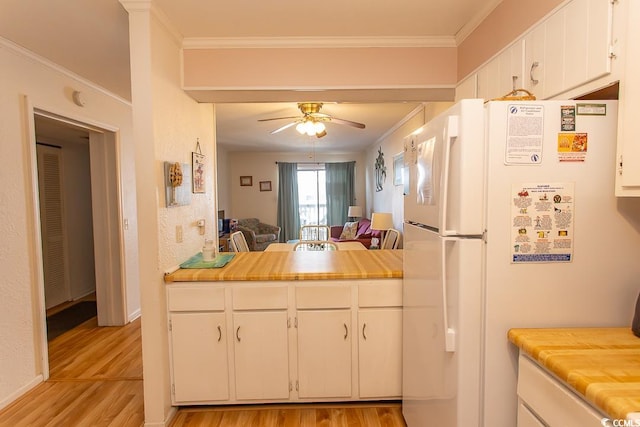 kitchen featuring ceiling fan, light hardwood / wood-style flooring, crown molding, and white fridge