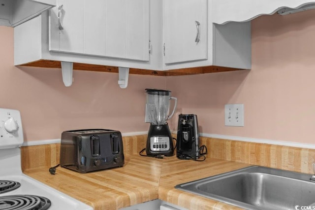 4305 S Ocean Blvd Unit 106, North Myrtle Beach, SC 29582 - kitchen view of white cabinetry and ventilation hood