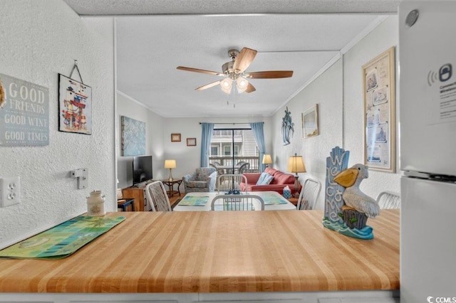 4305 S Ocean Blvd Unit 106, North Myrtle Beach, SC 29582 - dining space with ornamental molding, a textured wall, and ceiling fan