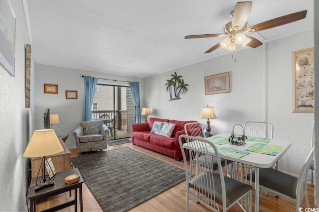 4305 S Ocean Blvd Unit 106, North Myrtle Beach, SC 29582 - living area with a ceiling fan, wood finished floors, crown molding, and a textured ceiling