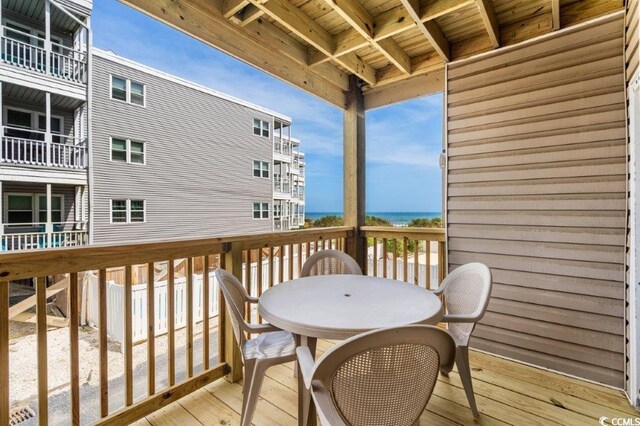 4305 S Ocean Blvd Unit 106, North Myrtle Beach, SC 29582 - wooden deck with outdoor dining area and a water view
