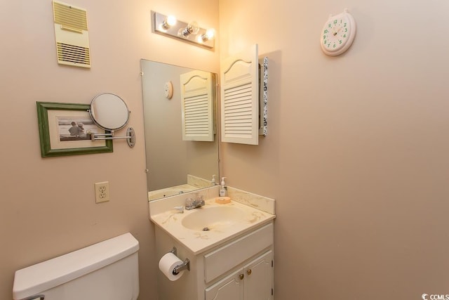 bathroom featuring toilet and vanity