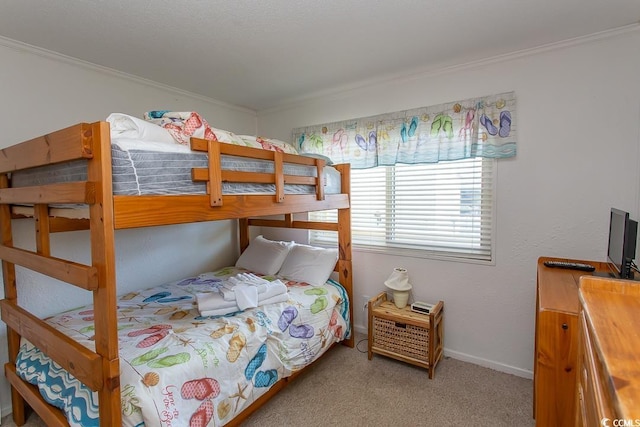 carpeted bedroom featuring baseboards and ornamental molding