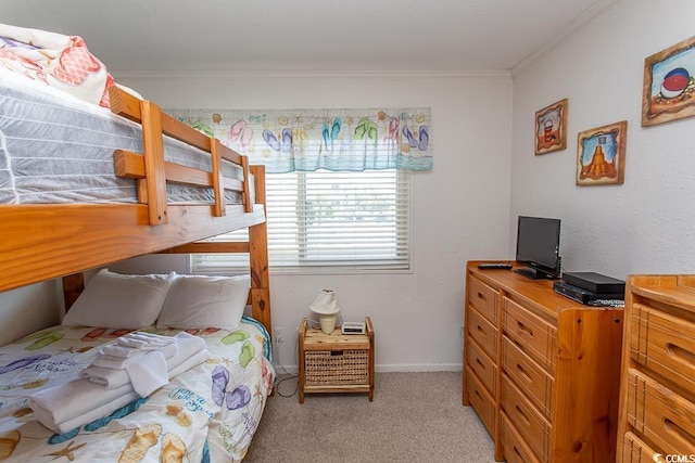 bedroom with crown molding, light colored carpet, and baseboards